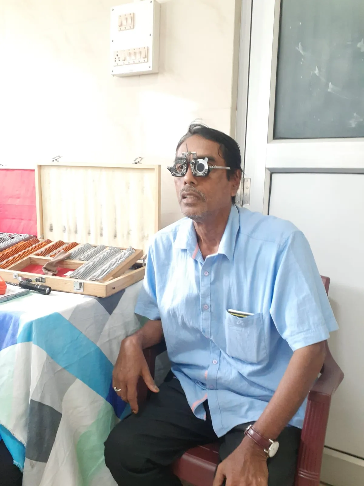 Optometrist examining eye condition at Sivasagar camp.